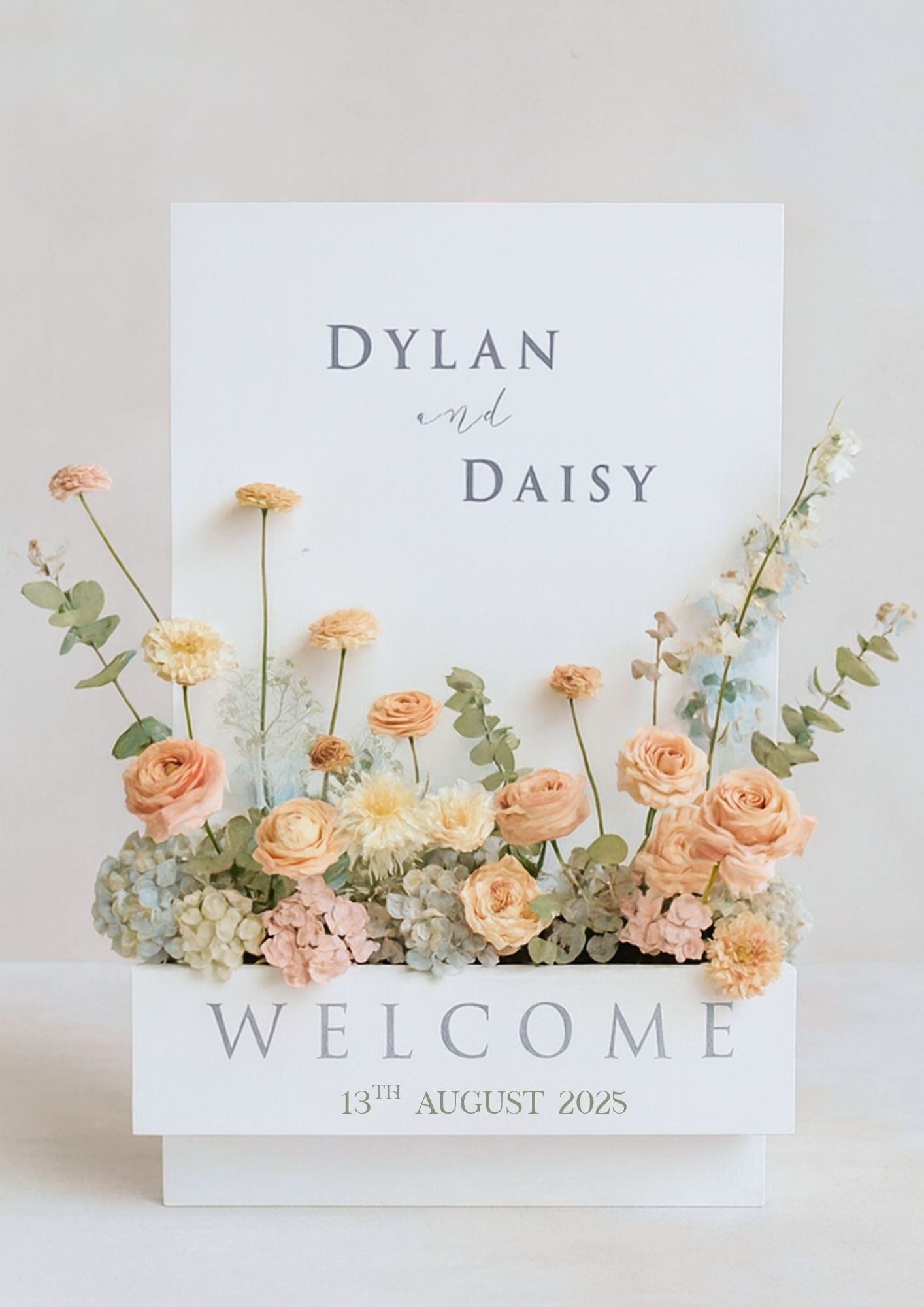 Floral arrangement in a box and welcome message.