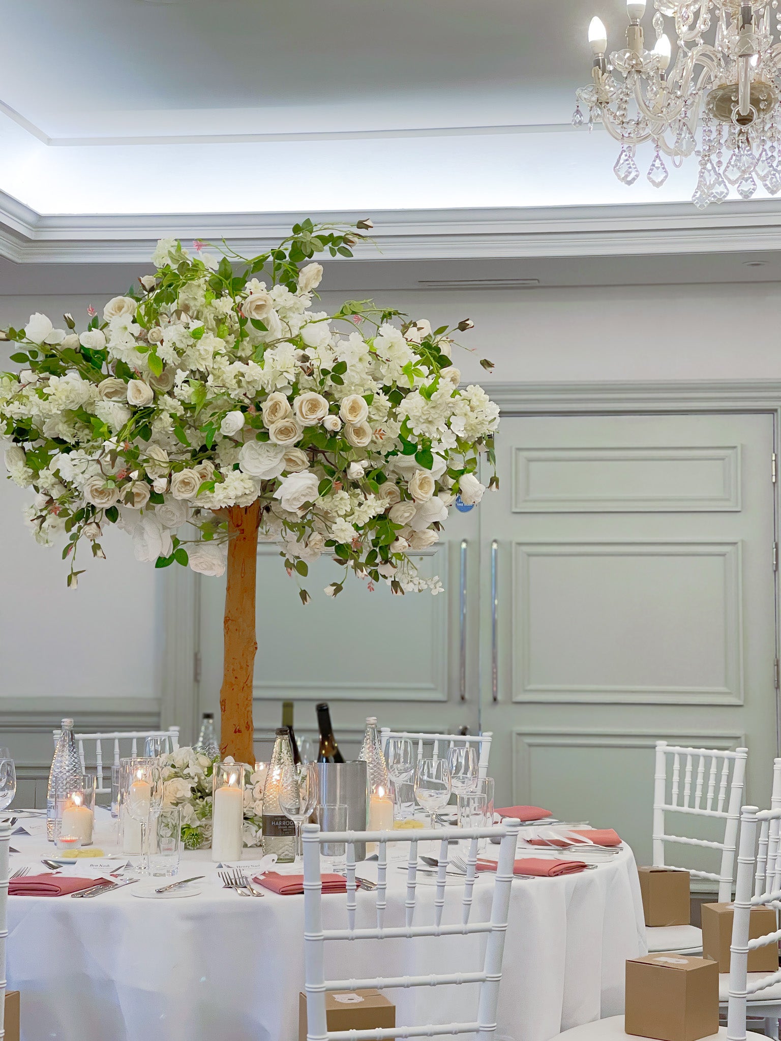Centerpieces featuring artificial tree and candles