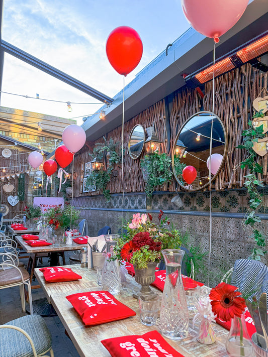 Red and pink balloons styled as a table decoration.