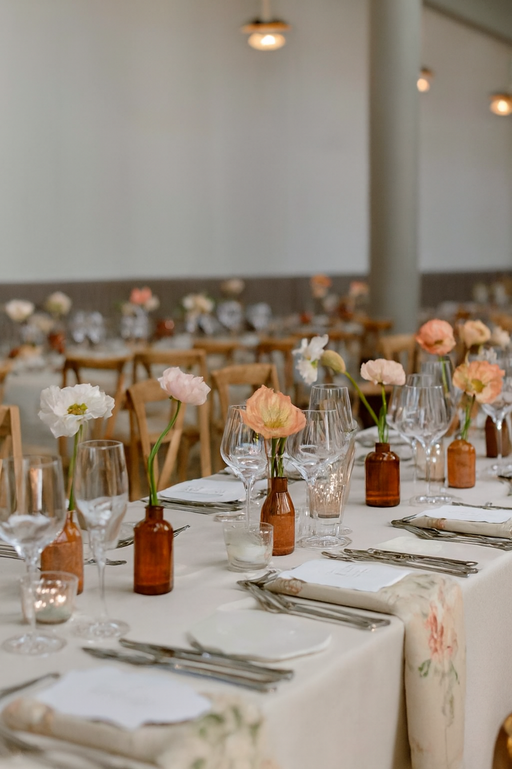 Wedding table styled with bud vases and pillar candles.