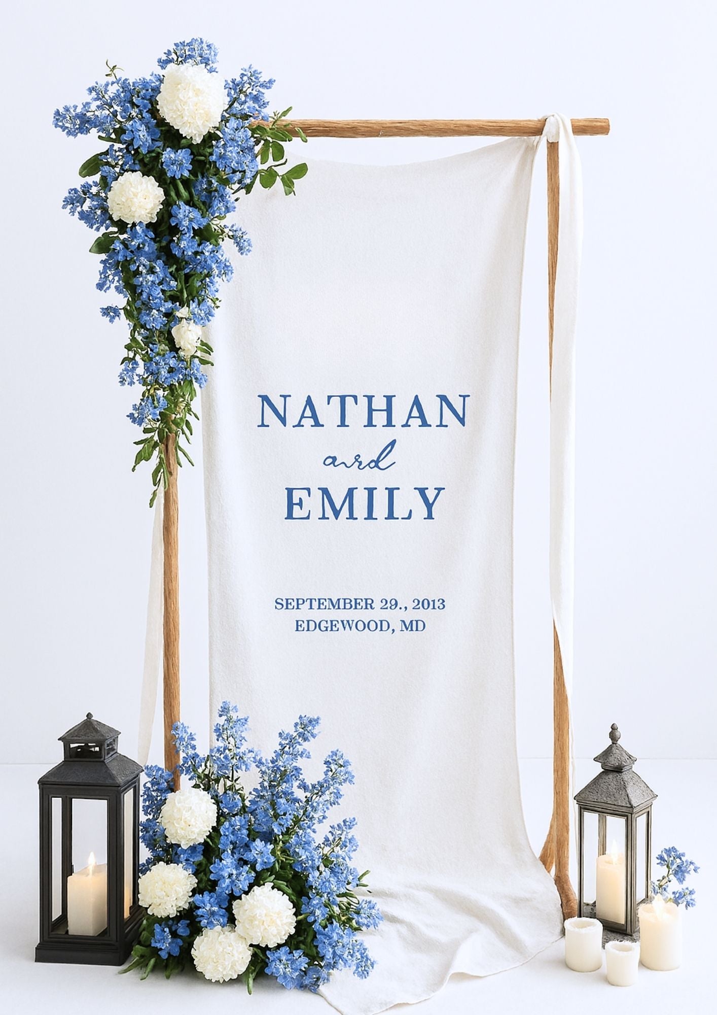 Fabric welcome sign on a wooden stand, decorated with flowers.