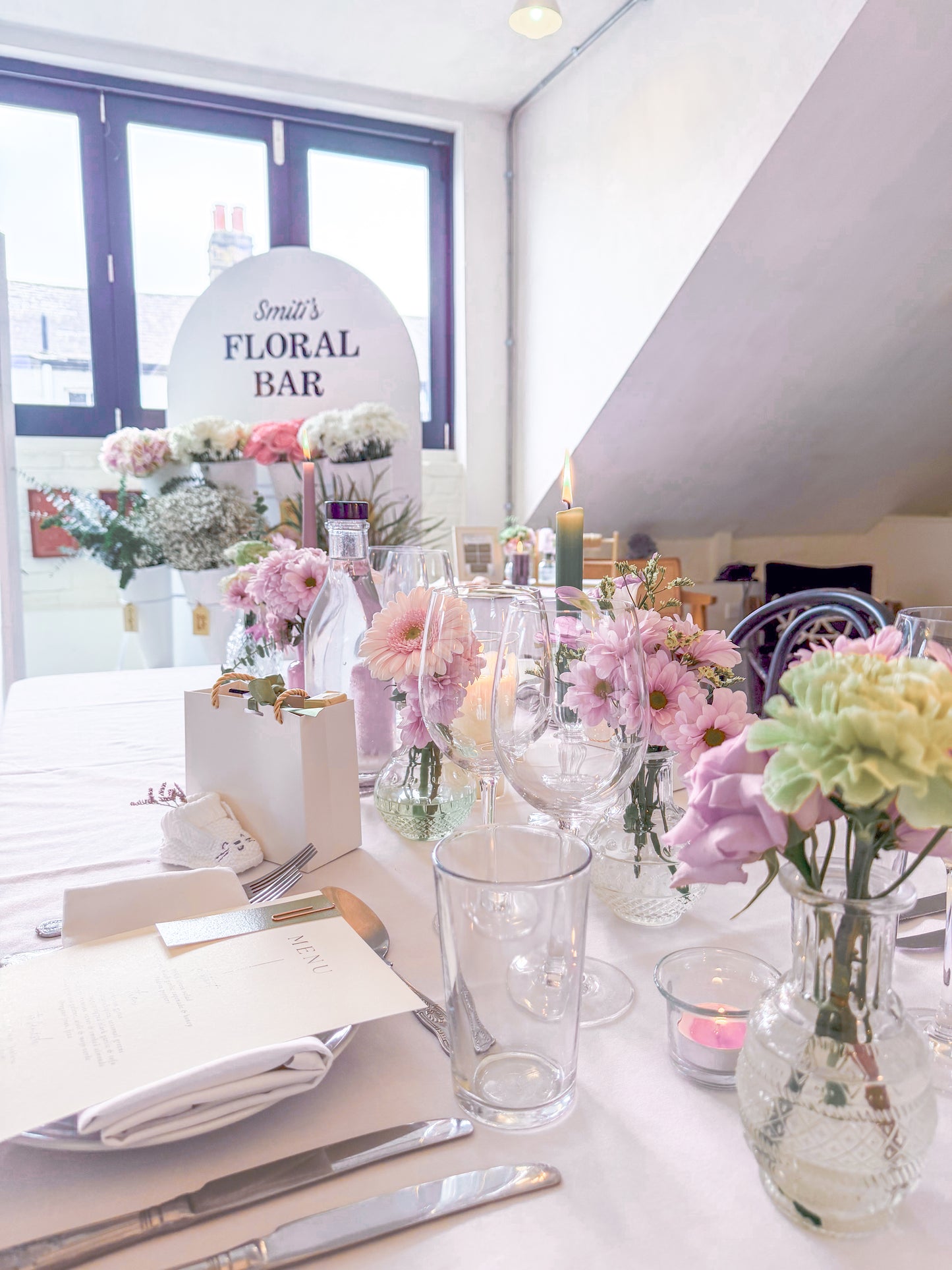 Table setting with floral decorations and a floral bar for guests
